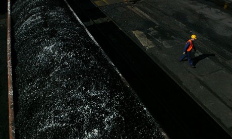 A worker walks past freshly-mined, high quality coal awaiting transport on a train at the Wieczorek coal mine April 14, 2004 in Katowice, Poland. Photograph: Sean Gallup/Getty Images A worker walks past freshly-mined, high quality coal awaiting transport on a tra